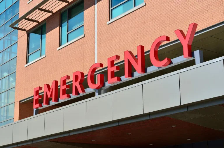 Illuminated emergency sign outside a medical building